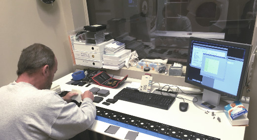 MRI system repairs by a man repairing equipment